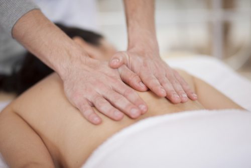 massage therapist working with client
