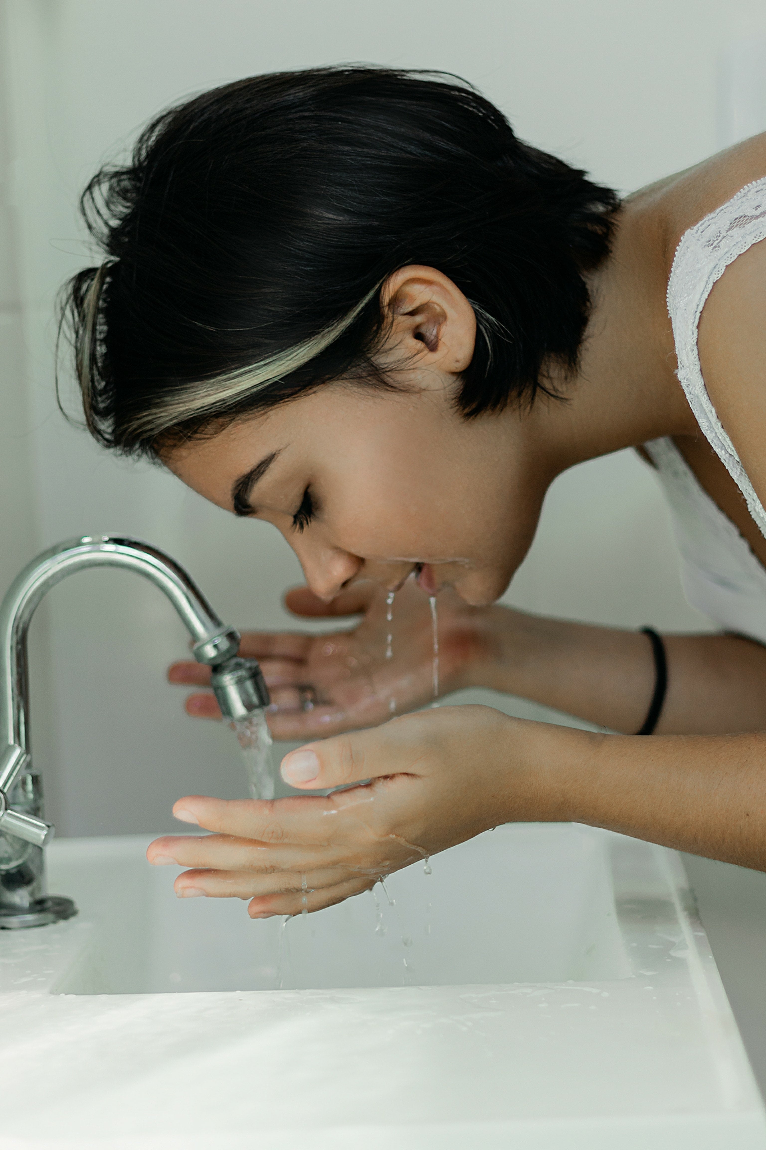 Woman washing her face.